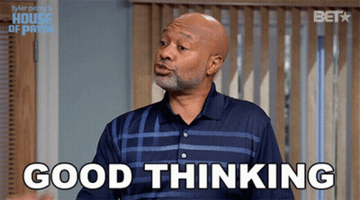 A Man In A Blue Shirt Says Good Thinking In Front Of A Window GIF