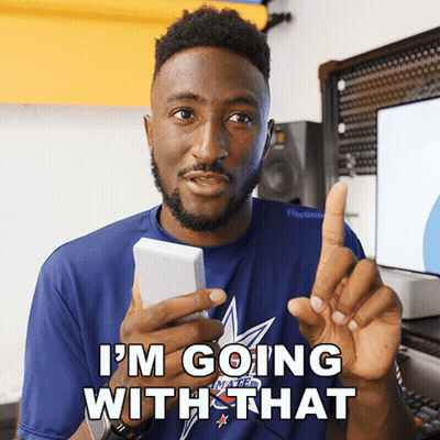 A Man In A Blue Shirt Says I 'M Going With That While Holding A Cell Phone GIF
