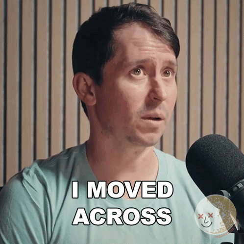 A Man In A Blue Shirt Says I Moved Across In Front Of A Microphone GIF