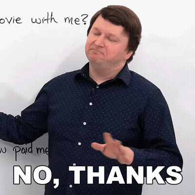 A Man In A Blue Shirt Says No Thanks In Front Of A White Board GIF