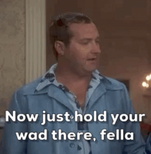 A Man In A Blue Shirt Says " Now Just Hold Your Wad There , Fella " GIF