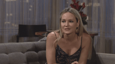 A Man In A Blue Shirt Sits In A Chair GIF