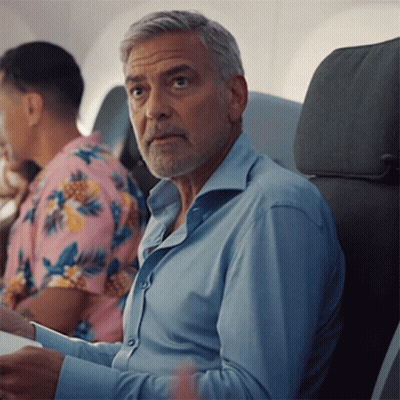 A Man In A Blue Shirt Sits In A Plane GIF