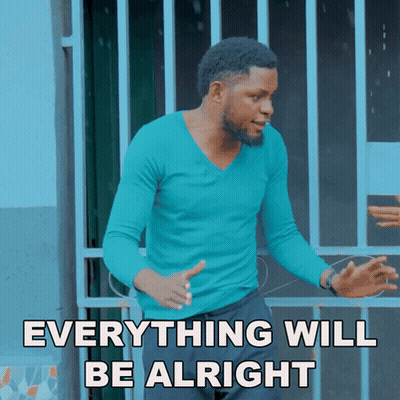 A Man In A Blue Shirt Stands In Front Of A Fence With The Words Everything Will Be Alright GIF