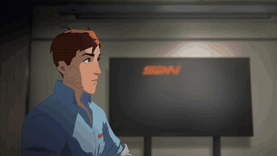 A Man In A Blue Shirt Stands In Front Of A Large Screen That Says Sdn GIF