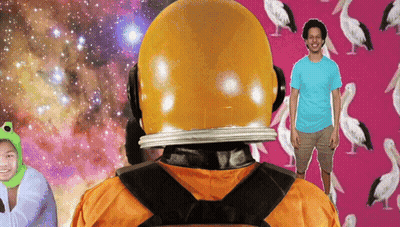 A Man In A Blue Shirt Stands In Front Of A Pink Background With Birds On It GIF