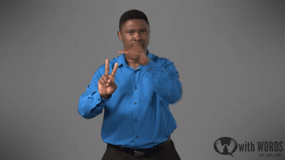 A Man In A Blue Shirt Stands In Front Of A Sign That Says " With Words " GIF