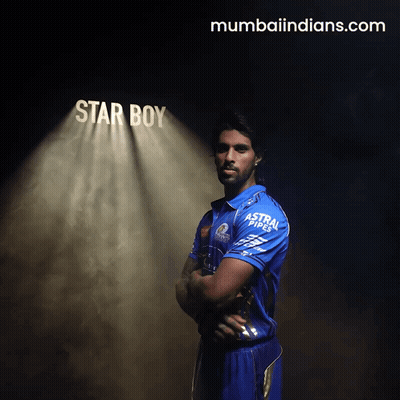 A Man In A Blue Shirt Stands In Front Of A Spotlight That Says Star Boy GIF