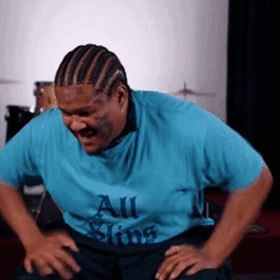A Man In A Blue Shirt That Says All Sins On It GIF