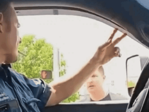 A Man In A Blue Shirt With A Badge That Says ' Emergency Services ' On It GIF