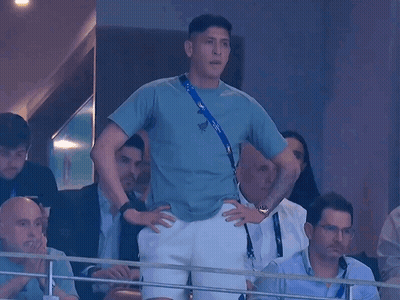 A Man In A Blue Shirt With A Lanyard Around His Neck That Says ' Russia ' On It GIF