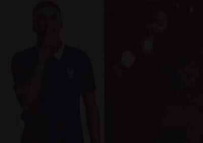A Man In A Blue Shirt With A Rooster On It Holds His Finger To His Lips GIF