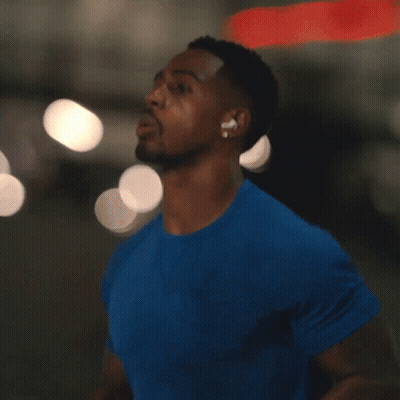A Man In A Blue Shirt With Ear Buds On GIF