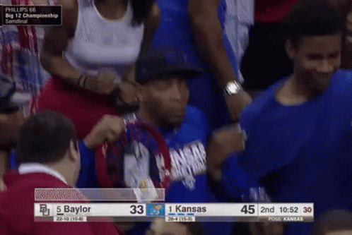 A Man In A Blue Shirt With Kansas On It GIF