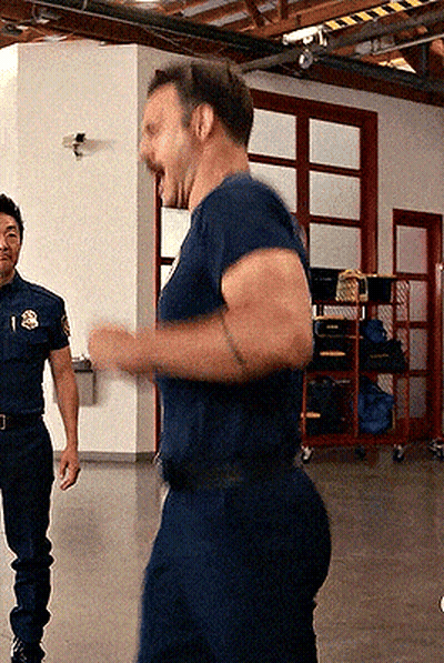 A Man In A Blue Shirt With The Letter S On His Chest GIF