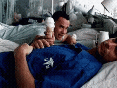 A Man In A Blue Shirt With The Letters U.s. On It Is Holding An Ice Cream Cone GIF
