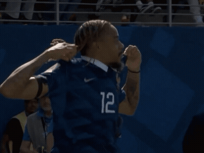 A Man In A Blue Shirt With The Number 12 On The Sleeve GIF