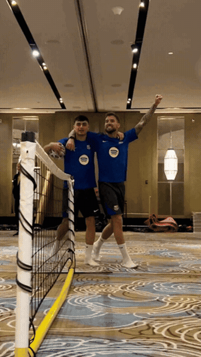 A Man In A Blue Shirt With The Word United On It Stands Next To Another Man In A Black Shirt GIF