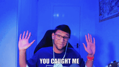 A Man In A Blue Shirt With The Words You Caught Me On It GIF