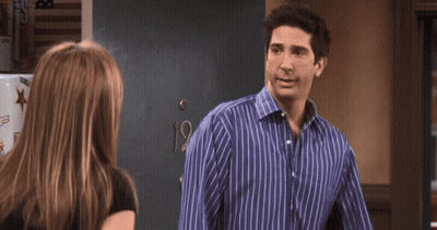 A Man In A Blue Striped Shirt Is Talking To A Woman In A Black Shirt And Says You Know What GIF