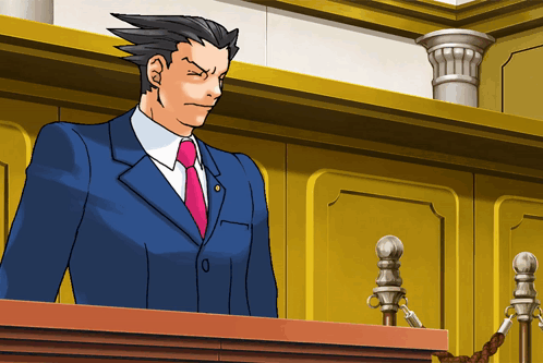 A Man In A Blue Suit And Pink Tie Stands At A Podium GIF