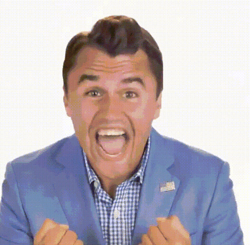 A Man In A Blue Suit And Plaid Shirt Is Making A Funny Face With His Mouth Open GIF