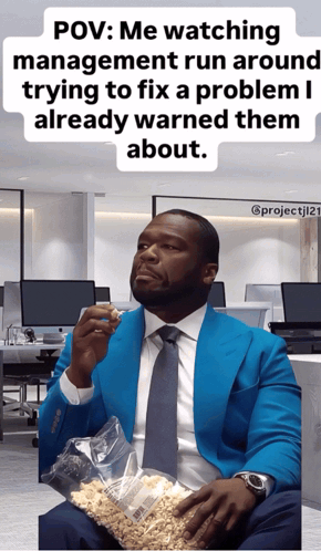 A Man In A Blue Suit And Tie Is Holding A Bag Of Peanuts GIF