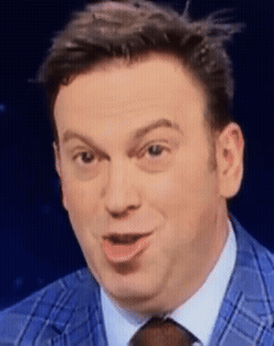 A Man In A Blue Suit And Tie Is Making A Face GIF