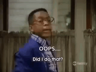 A Man In A Blue Suit And Tie Is Standing In Front Of A Window And Saying Oops ... Did I Do That ? GIF