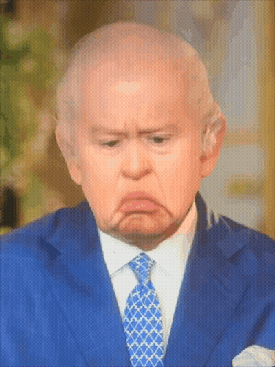 A Man In A Blue Suit And Tie Making A Sad Face GIF