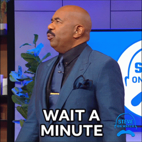 A Man In A Blue Suit And Tie Says Wait A Minute GIF