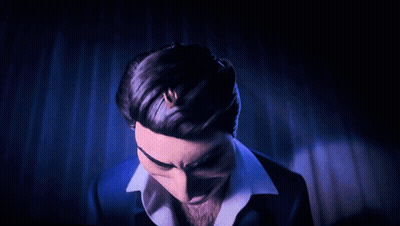 A Man In A Blue Suit And White Shirt Is Making A Funny Face GIF