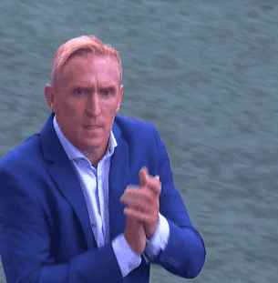 A Man In A Blue Suit Giving A Thumbs Up Sign GIF