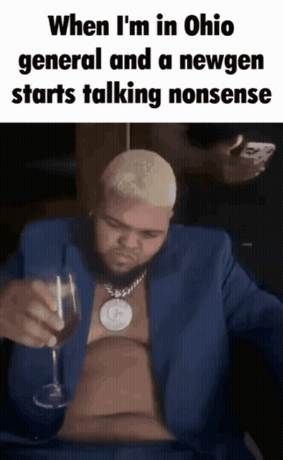 A Man In A Blue Suit Holds A Glass Of Wine GIF