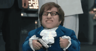 A Man In A Blue Suit Holds A Gun GIF