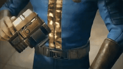 A Man In A Blue Suit Is Holding A Gun In His Hand . GIF