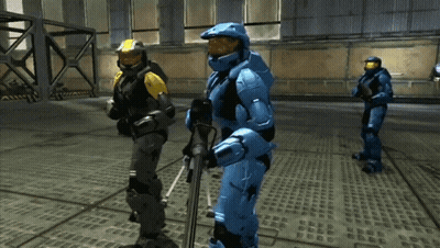 A Man In A Blue Suit Is Holding A Rifle GIF