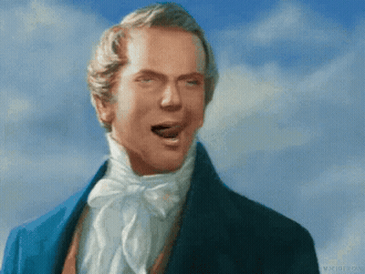 A Man In A Blue Suit Is Making A Face With His Mouth Open GIF