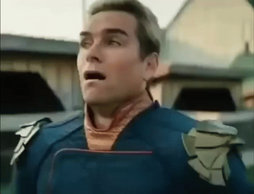 A Man In A Blue Suit Is Standing In Front Of A Building With His Mouth Open And His Eyes Closed . GIF