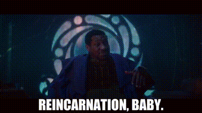 A Man In A Blue Suit Is Standing In Front Of A Stained Glass Window . GIF