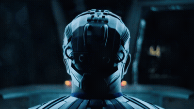 A Man In A Blue Suit Is Standing Next To A Woman In White GIF