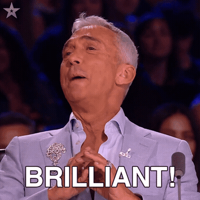 A Man In A Blue Suit Says Brilliant In Front Of A Microphone GIF