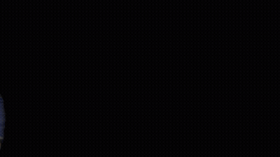 A Man In A Blue Suit Stands In Front Of A Mpire Estates Logo GIF