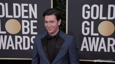 A Man In A Blue Suit Stands In Front Of A Sign That Says Olden Lobe Wards GIF