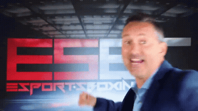 A Man In A Blue Suit Stands In Front Of A Sports Boxing Sign GIF