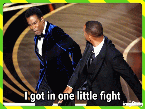 A Man In A Blue Suit Stands Next To Another Man In A Black Suit And Says " I Got In One Little Fight " GIF