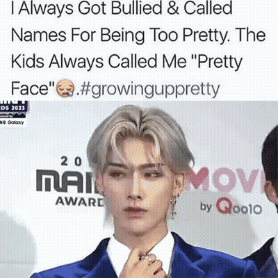 A Man In A Blue Suit Stands On A Red Carpet With A Caption That Says I Always Got Bullied GIF