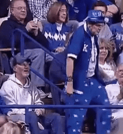 A Man In A Blue Suit With The Letter K On It GIF