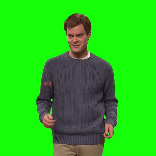 A Man In A Blue Sweater Holds His Hands Up In The Air GIF