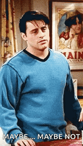 A Man In A Blue Sweater Is Standing In Front Of A Poster That Says Maybe Maybe Not GIF